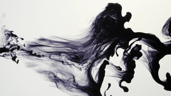 Droplet of ink squirted into water showing vortices and turbulence