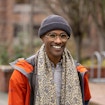 Portrait of smiling Sama Ahmed walking outside the University of Washington.