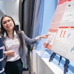 A photo of Faith Cerbo presenting her poster at the SURFiN Symposium.