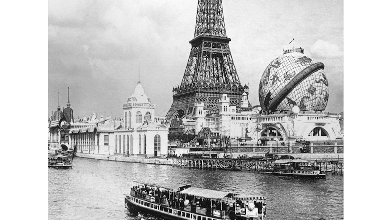 A Photo of the Eiffel Tower and a big globe viewed across the river Seine.