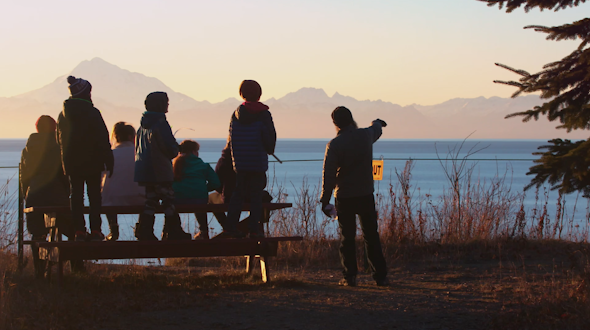 7 people enjoying views of mountains and water
